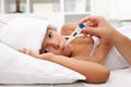 Sick child with fever laying in bed Royalty Free Stock Photo