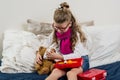 Sick child girl in glasses, heals his sick Teddy bear