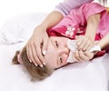 Sick child with handkerchief in bed. Royalty Free Stock Photo