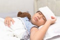 Sick child with high fever laying in bed Royalty Free Stock Photo