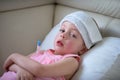 Sick child with high fever laying in bed Royalty Free Stock Photo