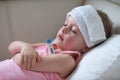 Sick child with high fever laying in bed Royalty Free Stock Photo