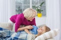 Sick child at home, mom standing close.