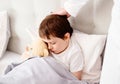 Sick child hugging a teddy bear Royalty Free Stock Photo
