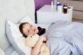 Sick child hugging a teddy bear Royalty Free Stock Photo