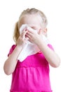 Sick child wiping or cleaning nose with tissue isolated