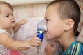 Sick children - baby girl and boy use nebulizer mask for inhalation, respiratory procedure by pneumonia or cough for child Royalty Free Stock Photo