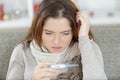 Sick cold woman looking at thermometre Royalty Free Stock Photo