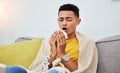 Sick, couch and man with flu sneeze due to cold, sinus and fever in a home living room with a blanket on a sofa Royalty Free Stock Photo