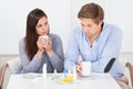 Sick couple drinking lemon tea at table