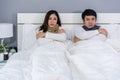 Sick couple feeling cold and suffering from virus disease and fever on bed Royalty Free Stock Photo