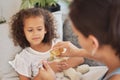 Sick daughter taking medicine as a treatment, cure or remedy while lying on the sofa for health and recovery at home