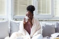 Sick day at home. African American woman has runny nose and common cold. Cough. Closeup Of Beautiful Young Woman Caught Cold Or Royalty Free Stock Photo