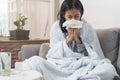 Sick day at home. Asian woman has runny and common cold Royalty Free Stock Photo