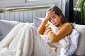 Sick day at home. Young woman has runny nose and common cold. Cough. Closeup Of Beautiful Young Woman Caught Cold Or Flu Illness. Royalty Free Stock Photo