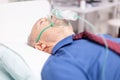 Sick elderly man infected with covid19 breathing through oxygen mask Royalty Free Stock Photo