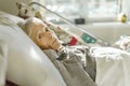 Sick, elderly senior woman in a hospital bed Royalty Free Stock Photo