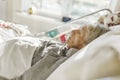 Sick, elderly senior woman in a hospital bed Royalty Free Stock Photo