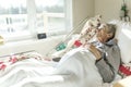 Sick, elderly senior woman in a hospital bed Royalty Free Stock Photo