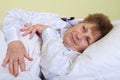 Sick elderly woman lying in bed Royalty Free Stock Photo