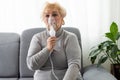 Sick elderly woman making inhalation Royalty Free Stock Photo