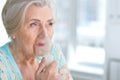 Sick elderly woman making inhalation Royalty Free Stock Photo