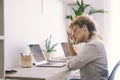 Sick exhausted Caucasian female work on laptop struggle with migraine or headache. Tired unwell young woman take off glasses Royalty Free Stock Photo