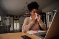 Sick exhausted young woman suffering from cold virus and coughing using paper napkins while working from home Royalty Free Stock Photo