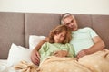 Sick father and son sleep in bed feel unhealthy