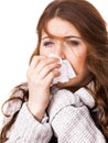Sick freezing woman sneezing in tissue