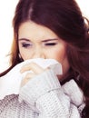 Sick freezing woman sneezing in tissue