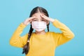 Sick Girl child in medical mask isolated on blue background