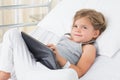 Sick girl with digital tablet in hospital bed Royalty Free Stock Photo