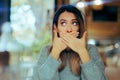 Burping Woman Covering her Mouth in a Restaurant