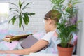 The sick girl lies in bed and fell asleep reading a book Royalty Free Stock Photo