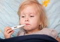 A sick girl is measuring the temperature Royalty Free Stock Photo