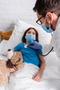 sick girl in medical mask lying