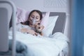 Sick girl with oxygen mask sleeping in a hospital bed with teddy Royalty Free Stock Photo