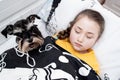 The sick girl is sleeping at the side of her puppy in bed Royalty Free Stock Photo