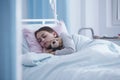 Sick girl sleeping with teddy bear in the hospital Royalty Free Stock Photo