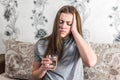 Sick girl suffering from head migraine, feeling pressure and stress. Woman holding pill and glass of water Royalty Free Stock Photo