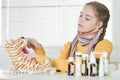 Sick girl with toy tiger sitting at table with medicine at home Royalty Free Stock Photo