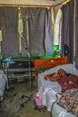 A sick woman rests on a gurney in a clinic in rural Haiti.