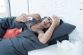 Sick latin woman in bed with a fever and cold. Royalty Free Stock Photo