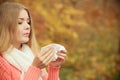 Sick ill woman in autumn park sneezing in tissue. Royalty Free Stock Photo