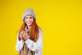 Sick illness redhaired ginger woman good looking wearing knitted sweater and hat with scarf drinking hot tea cup with