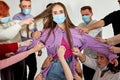 sick infected people touch young healthy female in mask like zombies