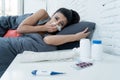 Sick latin woman in bed with a fever and cold. Royalty Free Stock Photo