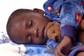 Sick little boy sleeping with his teddy bear Royalty Free Stock Photo