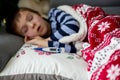 Sick little child, boy, with high fever sleeping on the couch at Royalty Free Stock Photo